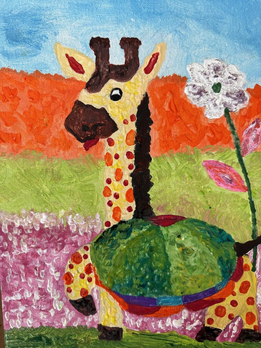 A student's giraffe in a poppy field